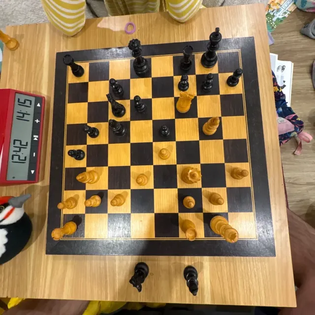 Photo of a wooden chess board mid-game, taken from above